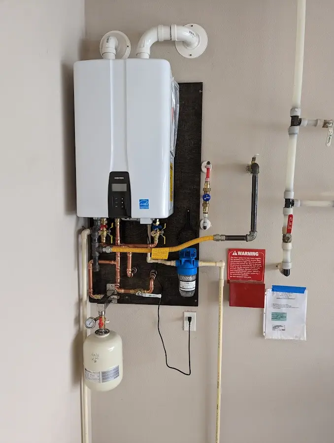 Professional plumber installing copper piping in a New Britain home